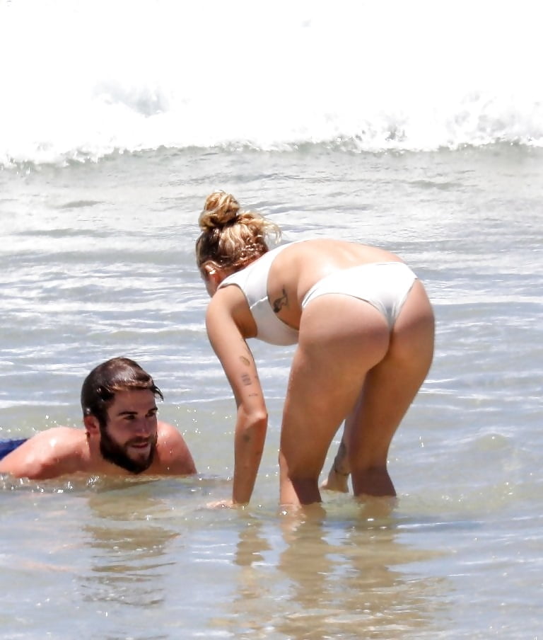 Miley Cyrus  wears a white bikini on the beach (7/17)