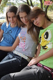 3_young_girls_remove_T-shirts_and_jeans_to_model_naked_on_park_bench (1/20)