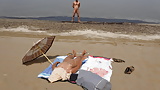Perv_watching_my_wife_sunbath_on_quiet_beach (1/3)