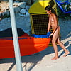 Nudist_girl_carries_inflatable_boat (1/7)