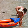 Nudist_girl_carries_inflatable_boat (5/7)